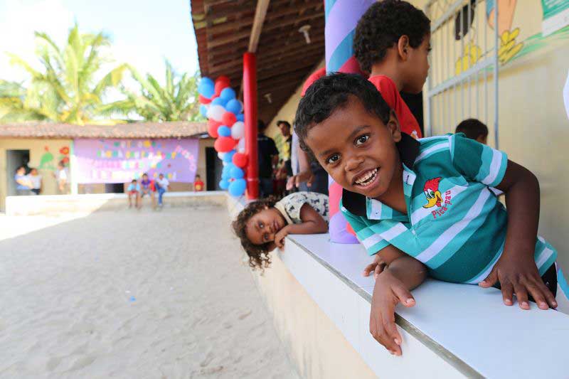 Children play at the wall at their child development center