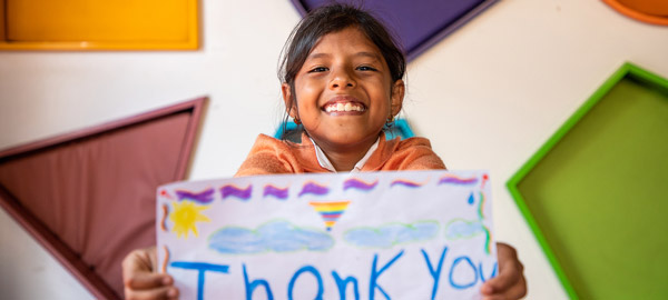 A child with thank you sign