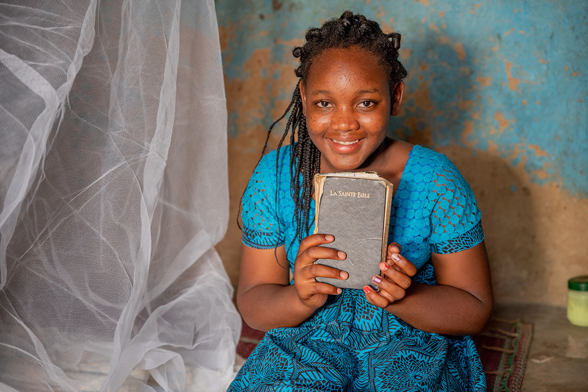 a girl holds her Bible