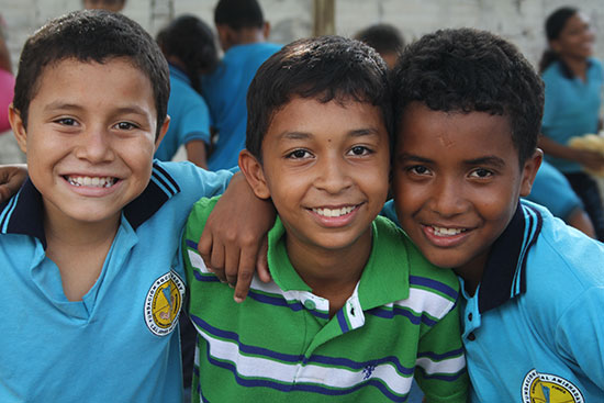 Three young boys smiling