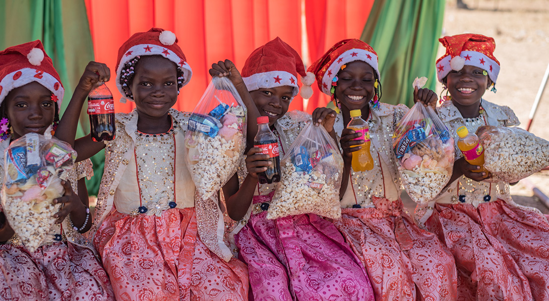 Girls in Burkina Faso enjoy a Christmas celebration where they received popcorn and soda.
