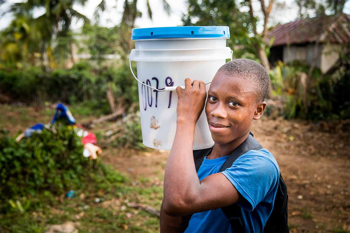 A young man carrying disaster relief supplies