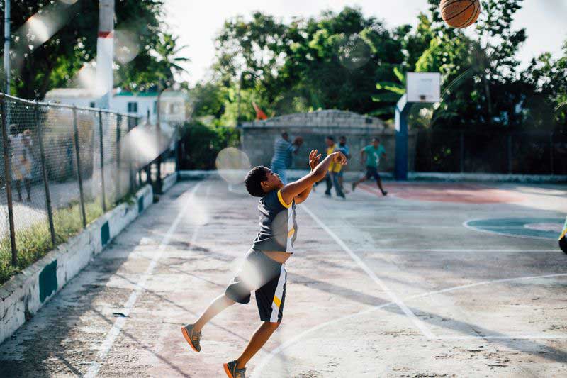 A boy shoots a basketball