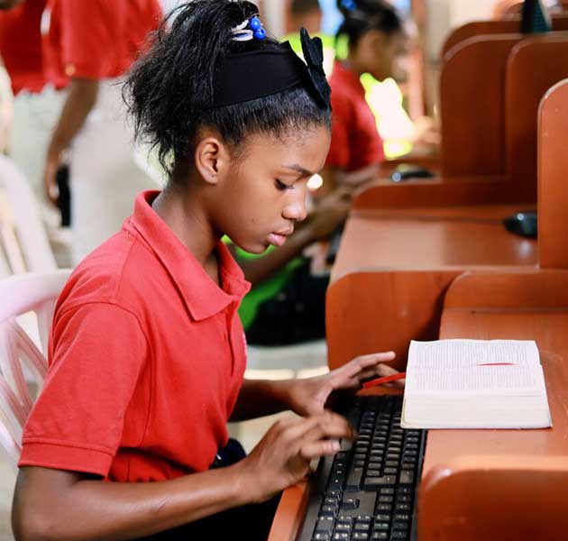 A girl working on the computer in her school