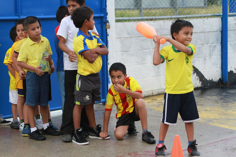 A group of boys play baseball at their child development center