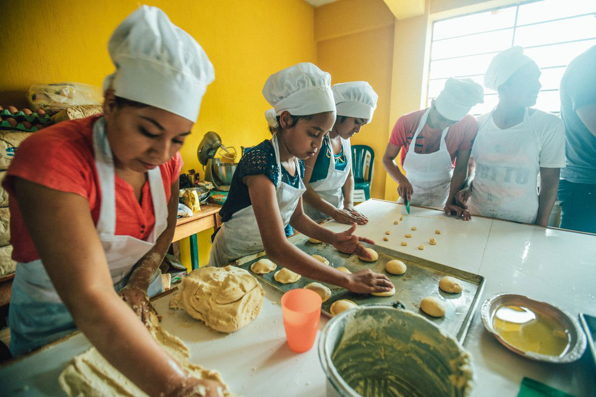 A group of children learn to bake as a part of a vocational training program