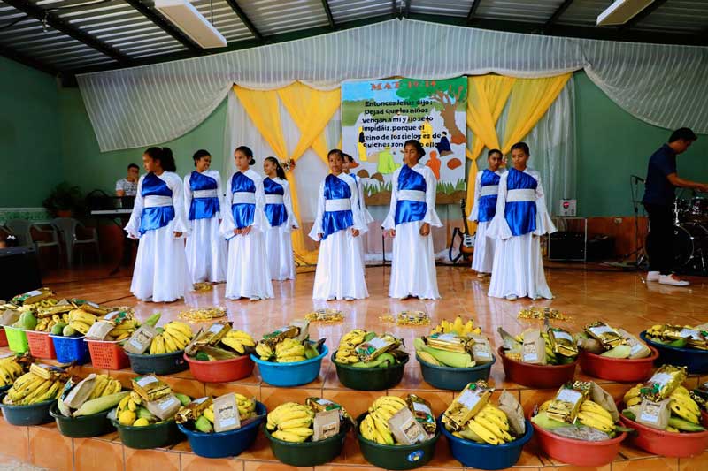 Teenage girls perform as a part of the First Fruits Feast at their church