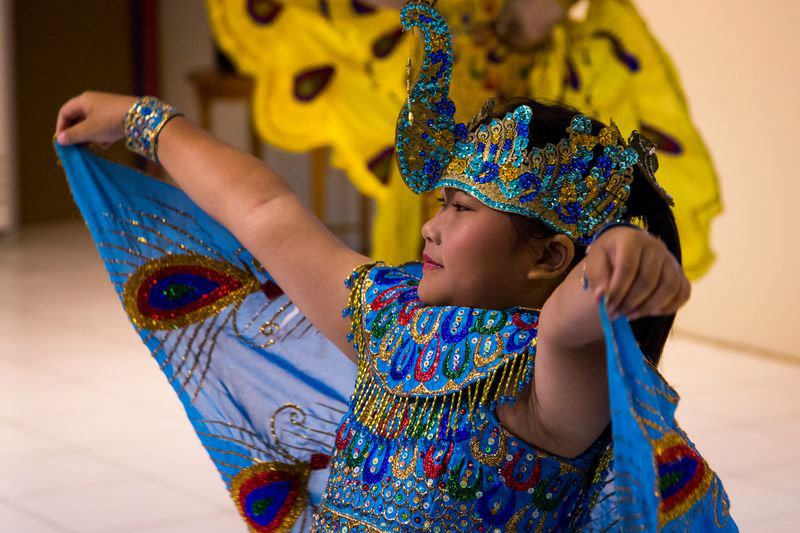 A young girl performs a cultural dance