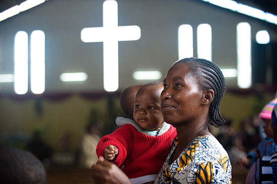 A mom holding her child while attending church