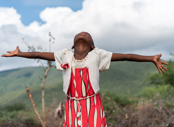 A young girl with her arms stretched out