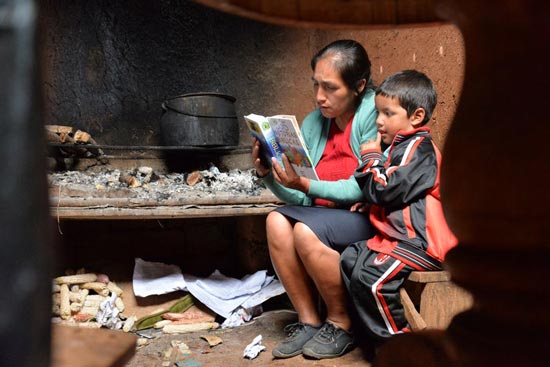 A mom reading the bible to young boy