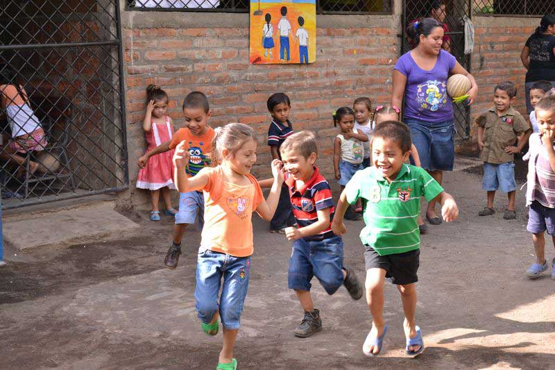 Children laugh and play together at their child development center