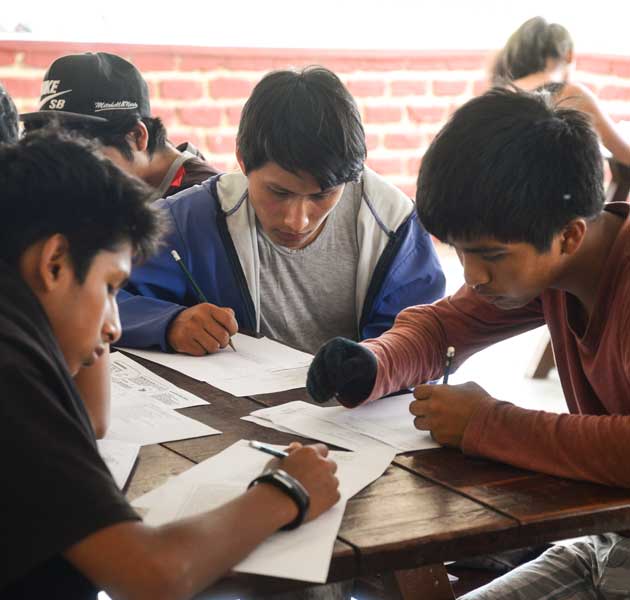 A group of boys working on their school work together