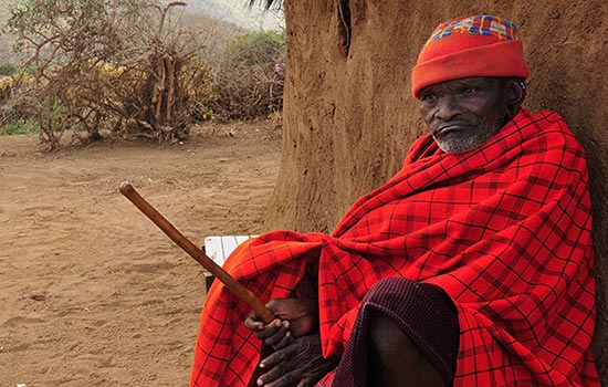 an elderly Maasai man in traditional Maasai garb