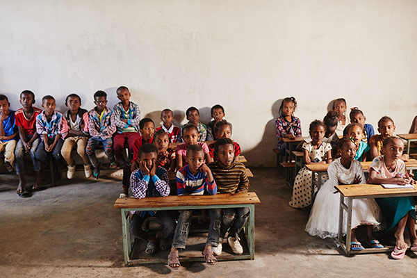 A group of children sitting at their desks in a classroom in Ethiopia