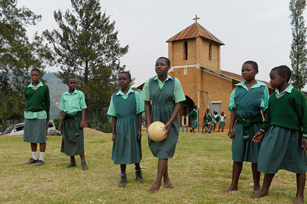 A group of girls playing soccer in front of their church