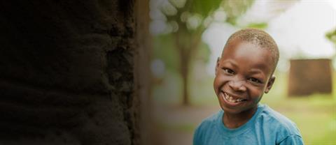 A boy from Uganda smiling