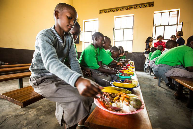 A group of children eat a delicious meal they received at their child development center