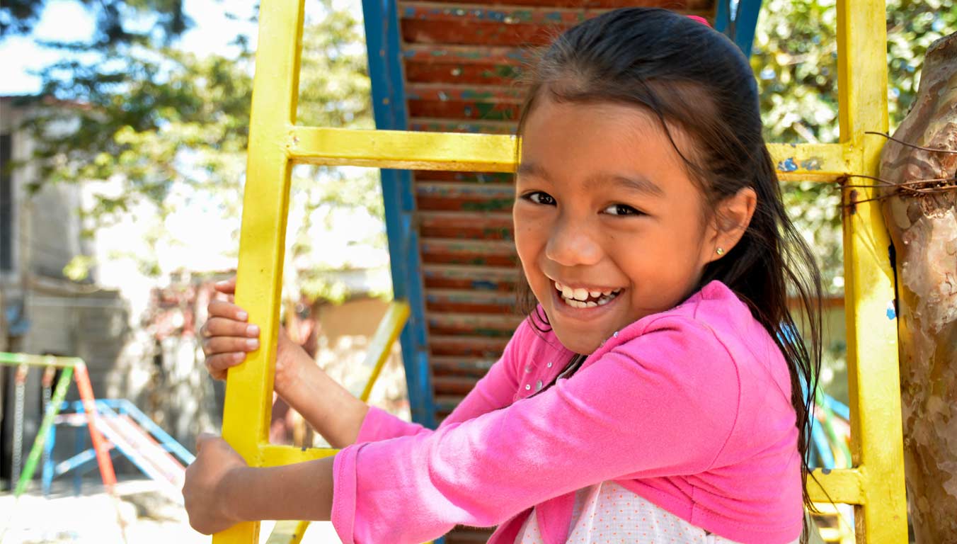 A girl playing on a playground in Honduras
