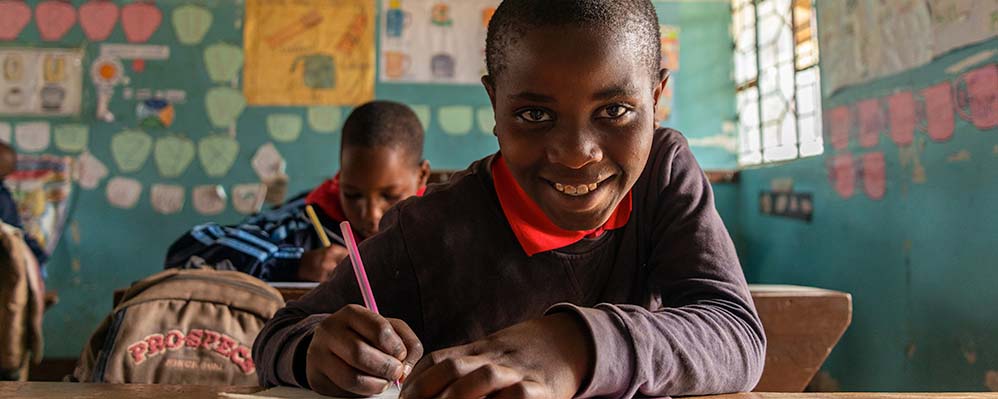 Child in Tanzania completing schoolwork