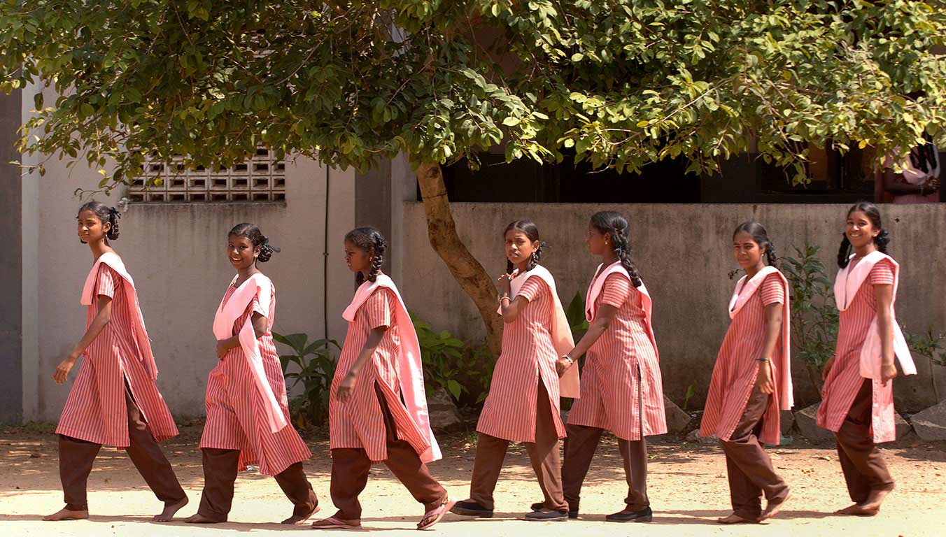 A group of young adults wearing their Indian uniforms walking together
