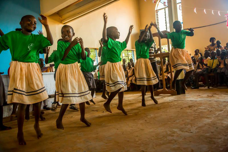 A group of girls dance at their child development center