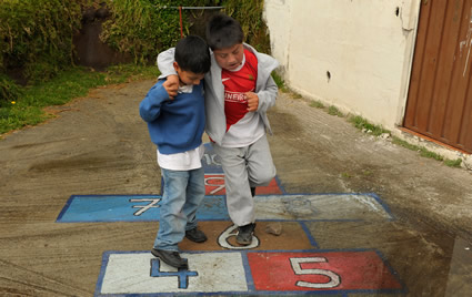 two boys playing hopscotch