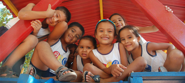 Children playing in a group and smiling