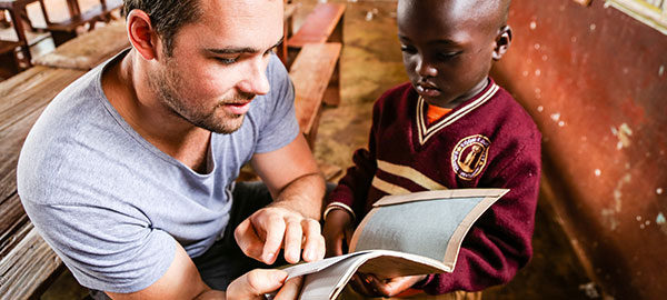 A sponsor reads with a child