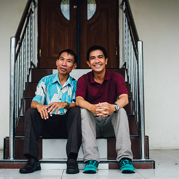 two men sitting on a set of stairs