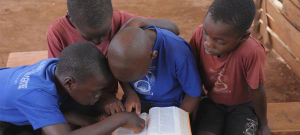 Children reading the bible together
