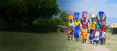 Woman and children with buckets on their heads, posing and smiling