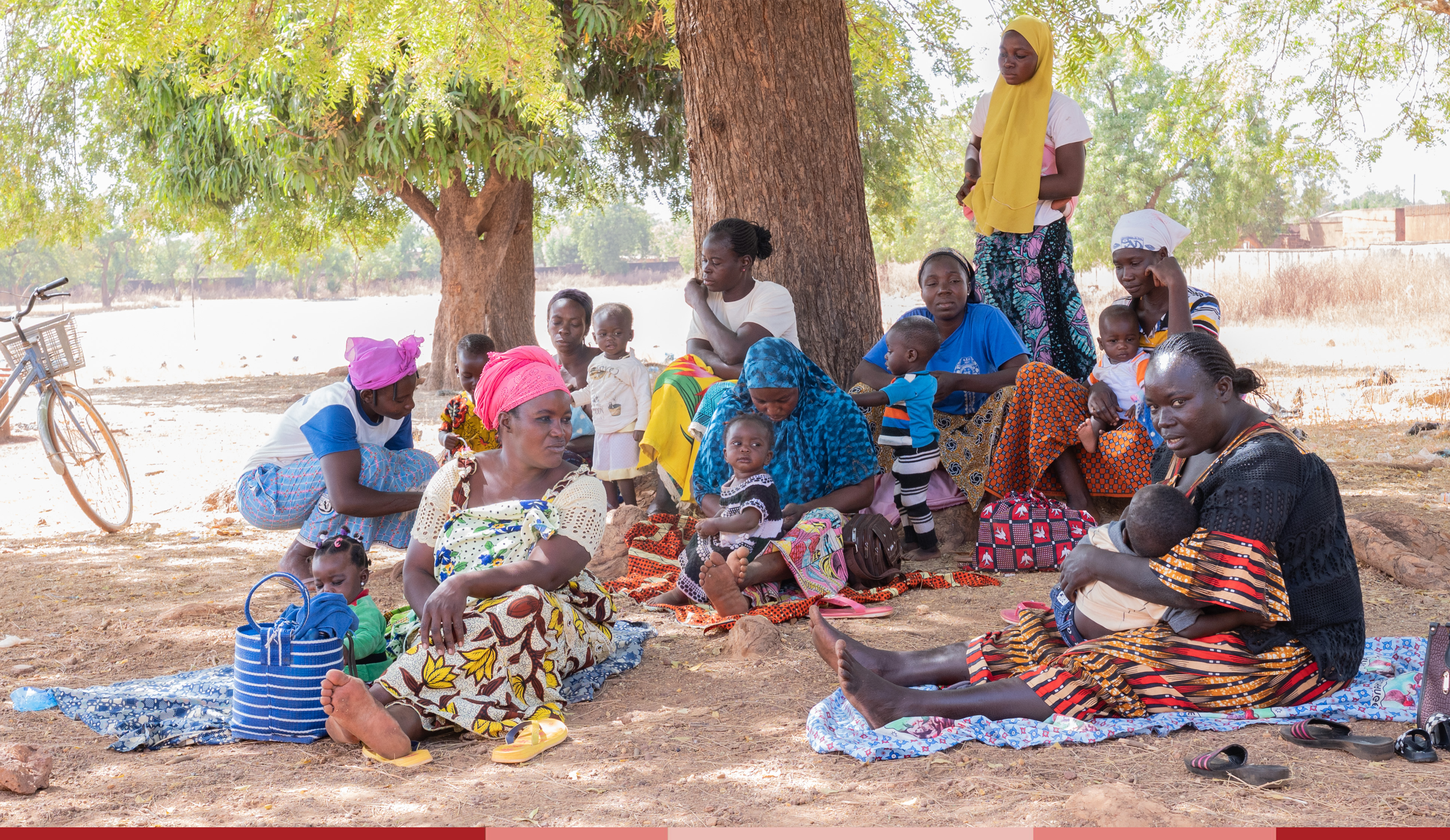 Moms gather outside with their babies to learn lessons at the Compassion Nurturers center