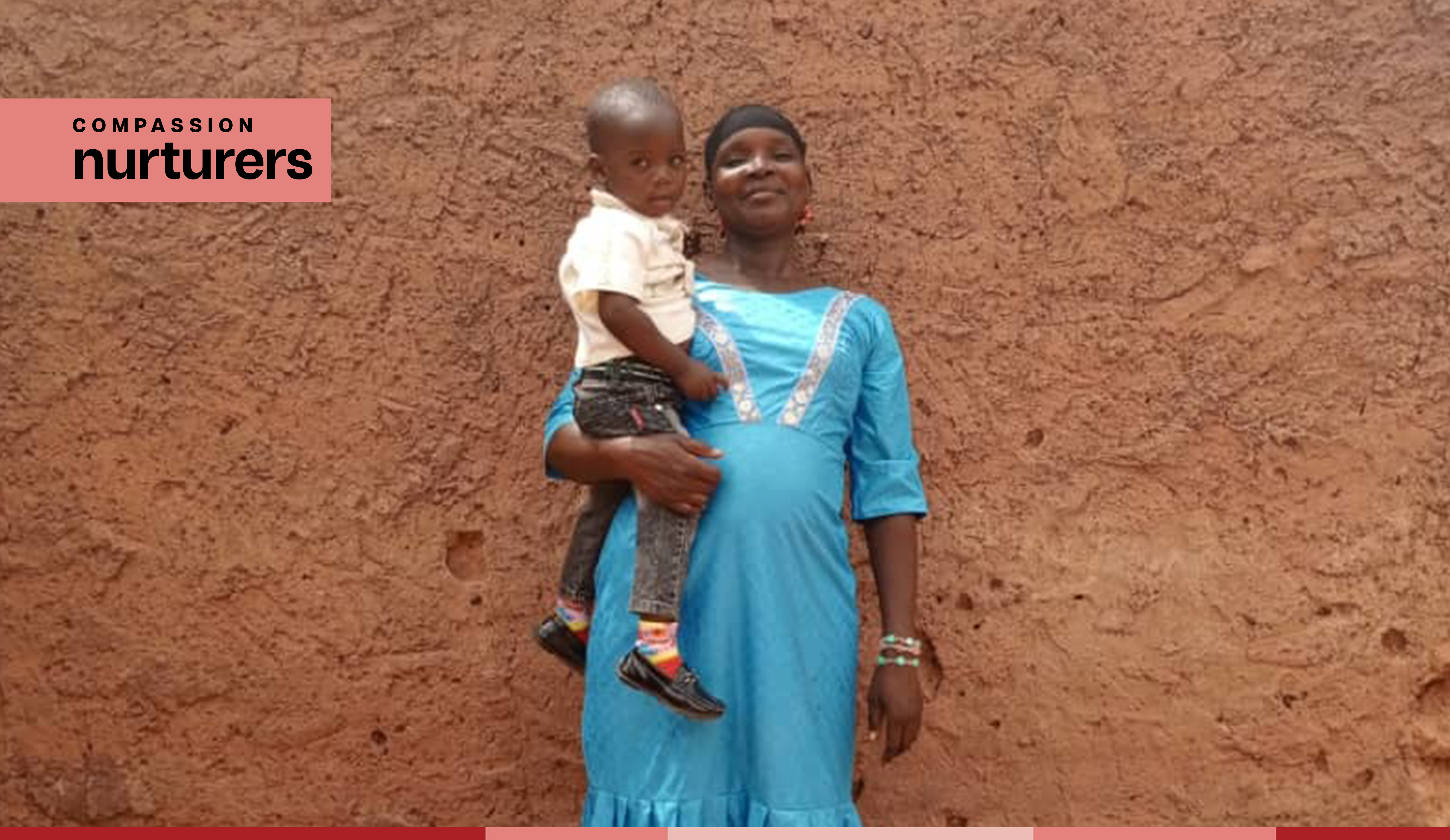 Maria stands proudly while holding baby Amza
