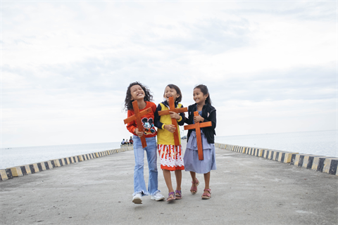 3 Little Girls smiling holding crosses