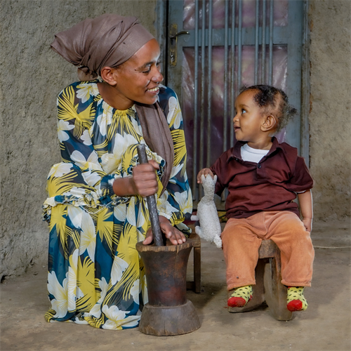 Tirunesh sits beside and smiles at her daughter