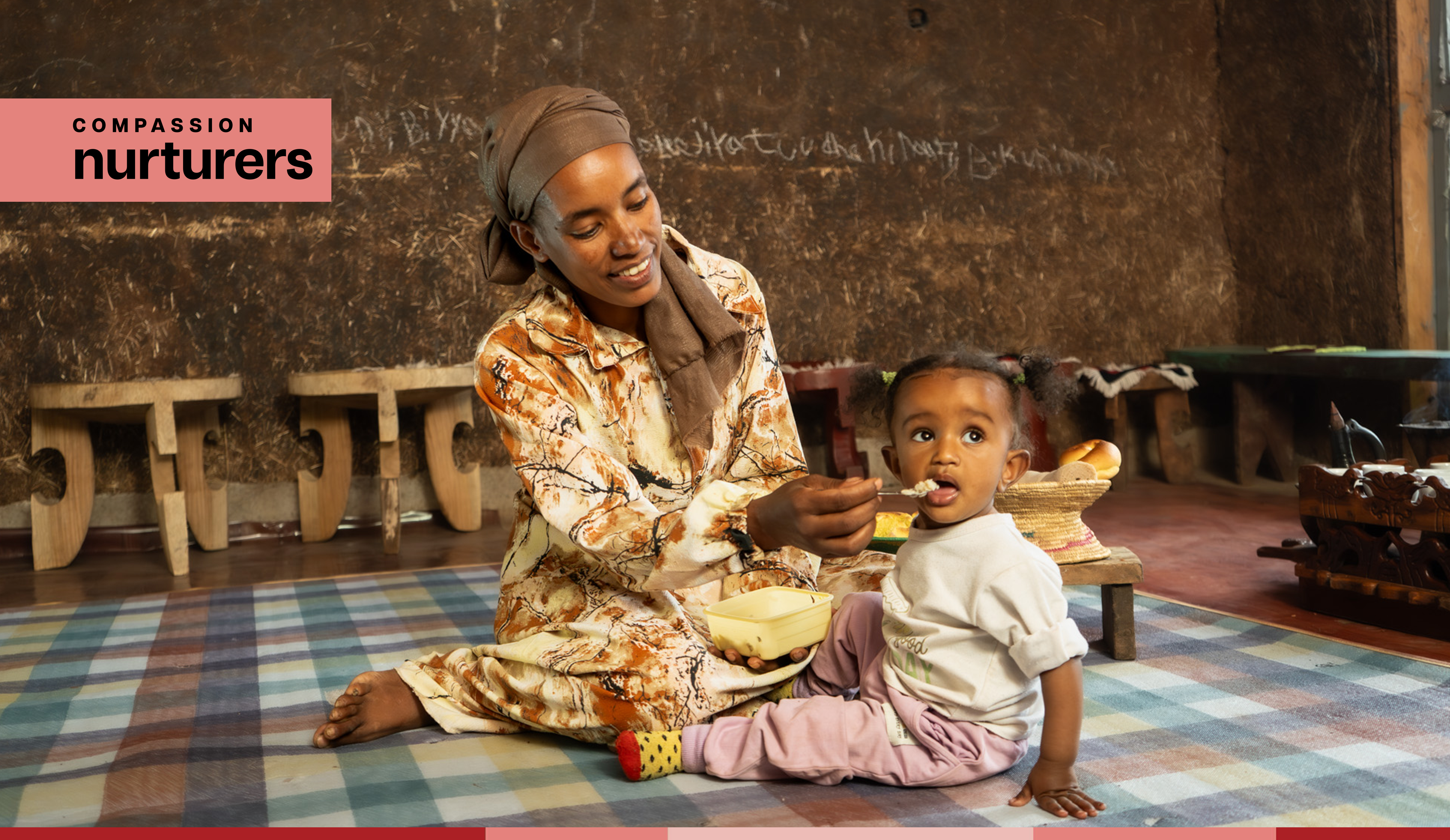 Tirunesh smiles while feeding baby Ididiya