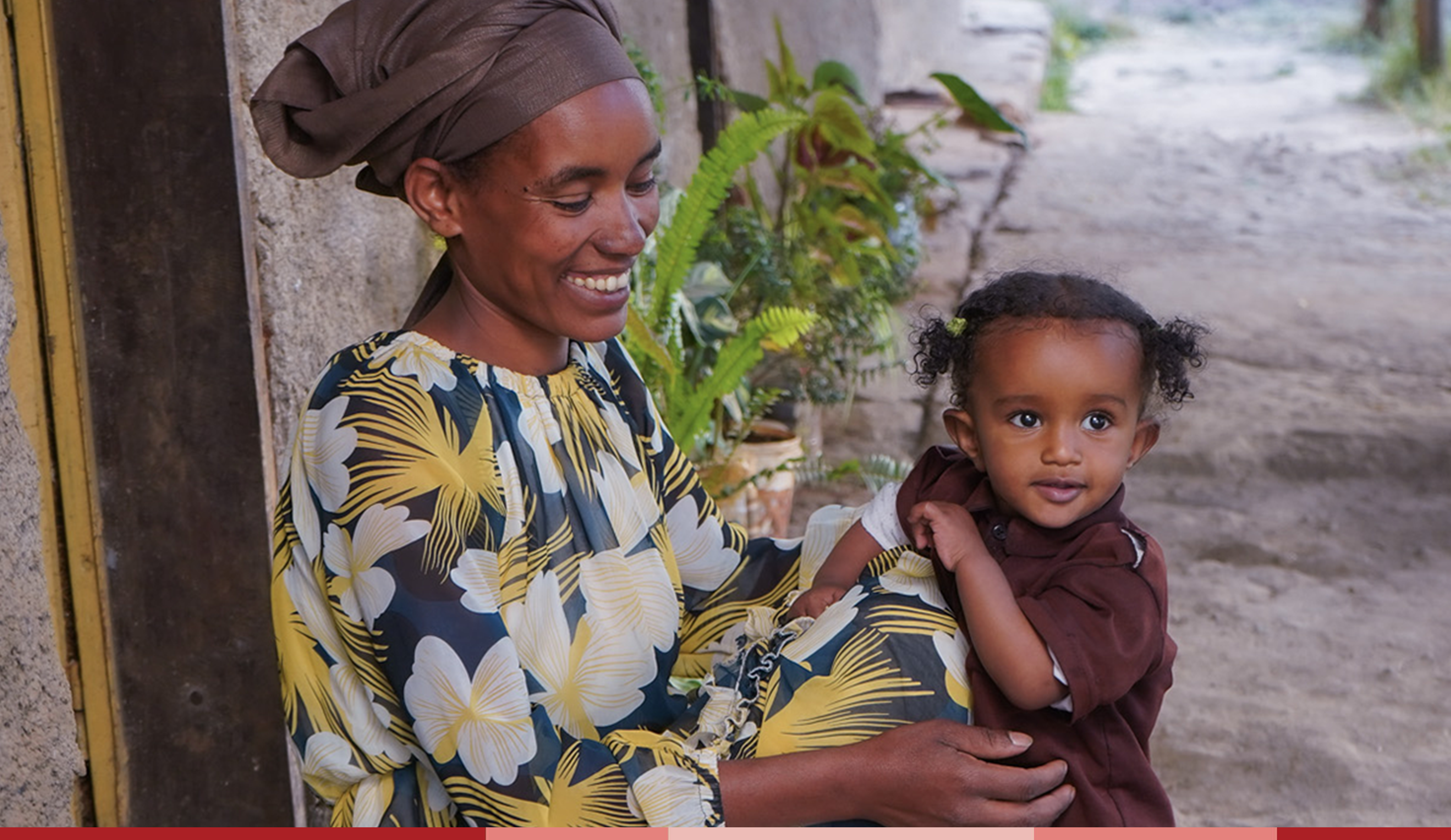 Tirunesh smiles at her baby who sits on her lap