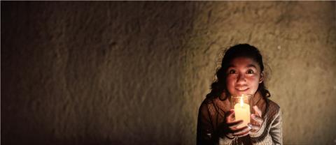 A girl holding a candle