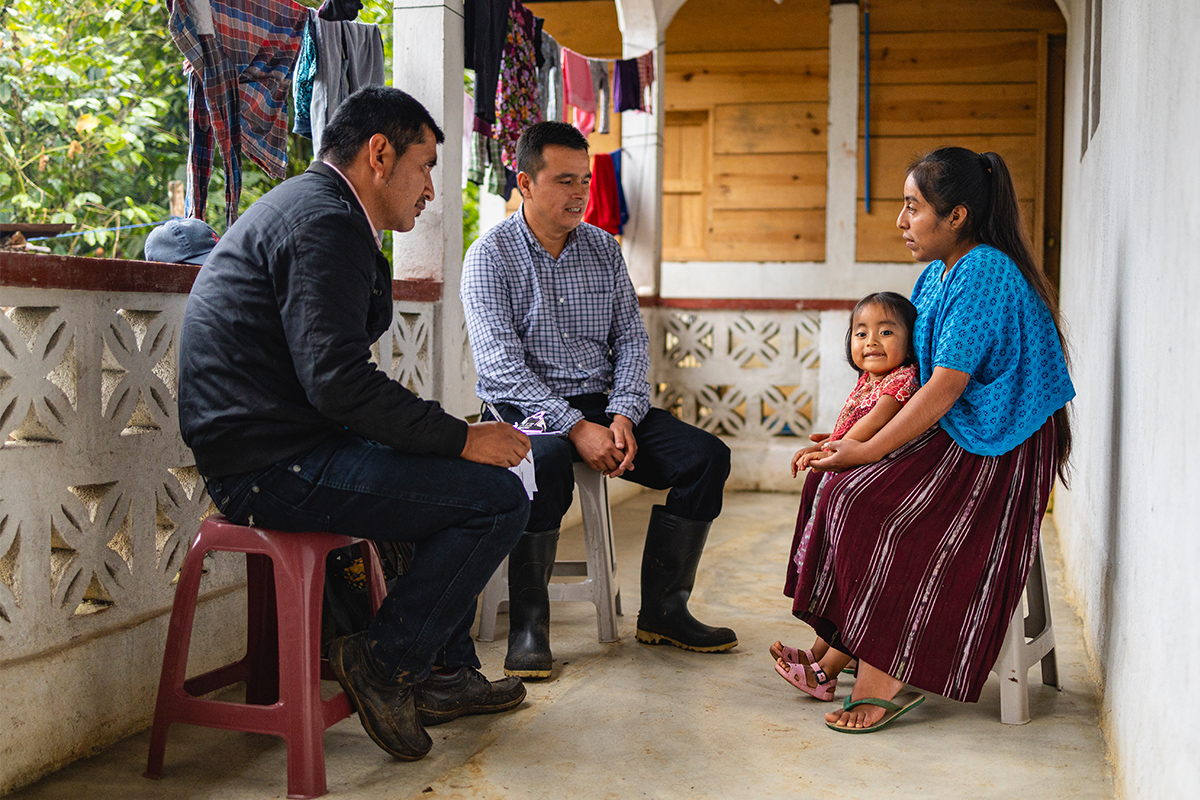 People sitting on chairs in a circle talking