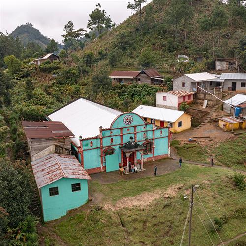 Man shakes woman's hand in doorway of house