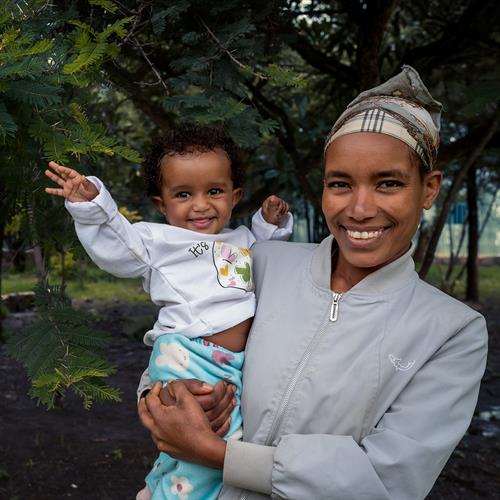 Tirunesh smiles while holding her baby