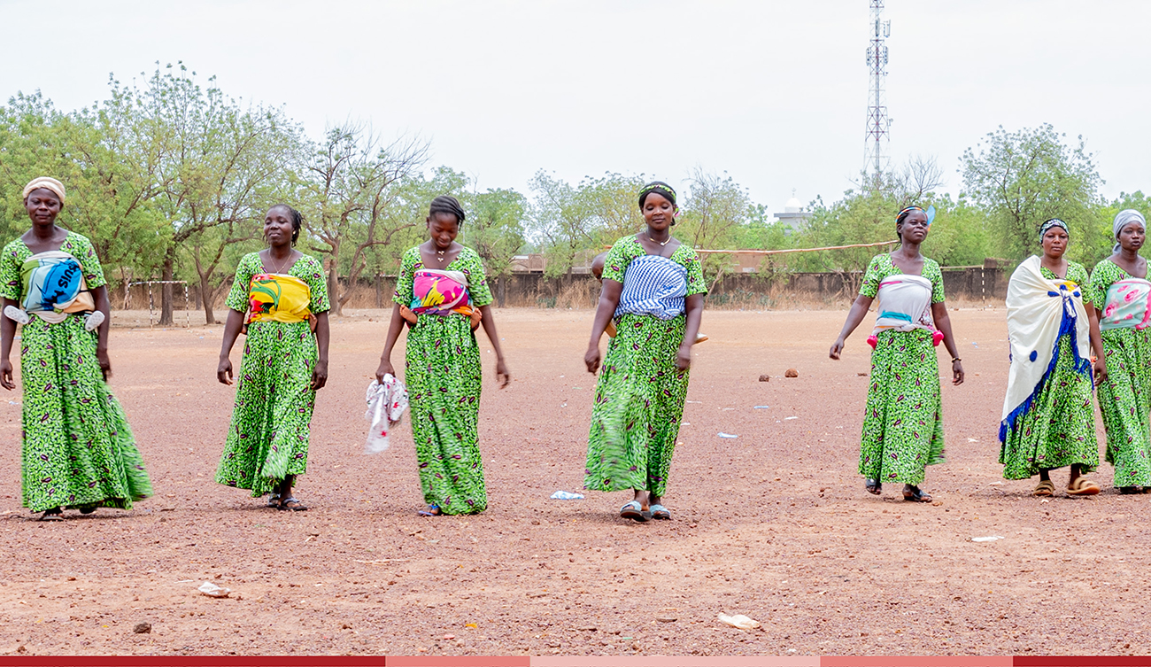 A group of moms walk together outside