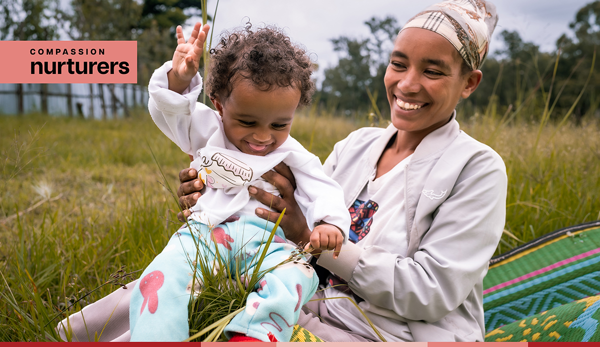 Tirunesh smiles while holding her baby
