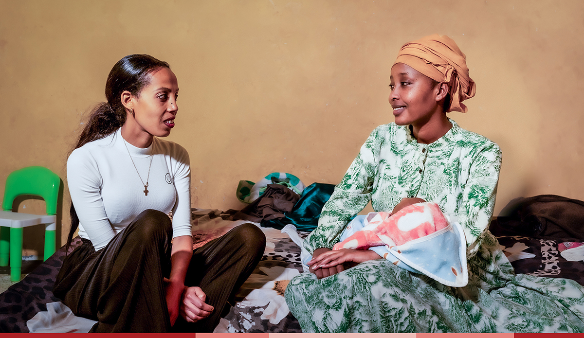 A Nurturers center staff member speaking to a mom