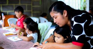 lady helps children write