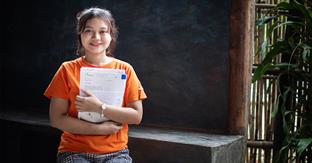 girl holds letter close