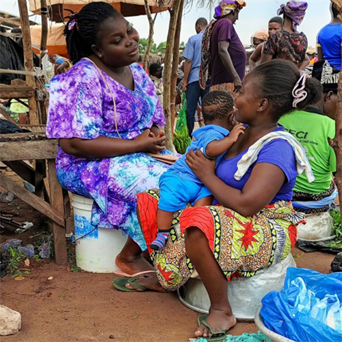 Mothers chatting happily in the marketplace