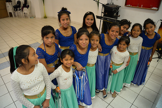 Secia and a group of girls in dance clothes at the Compassion center 