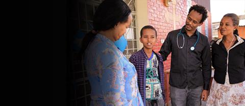 adults talking to a child